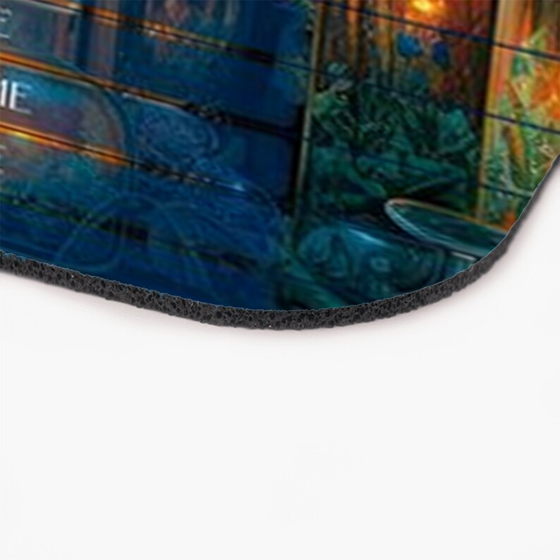May include: A blue and green mousepad with a fantasy-themed design. The design features a variety of intricate details, including a glowing orb, a wooden structure, and a variety of magical elements.
