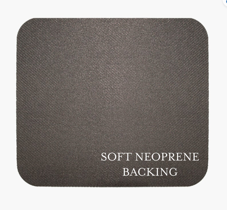 May include: A close-up of a dark gray mouse pad with the text "SOFT NEOPRENE BACKING" printed in white.