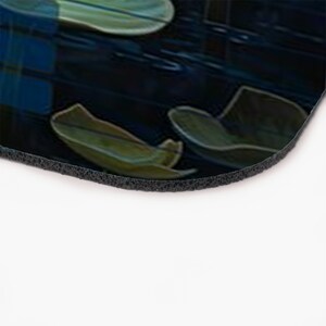 May include: A dark blue mouse pad with a design of green and blue leaves. The leaves are scattered across the pad and appear to be falling.