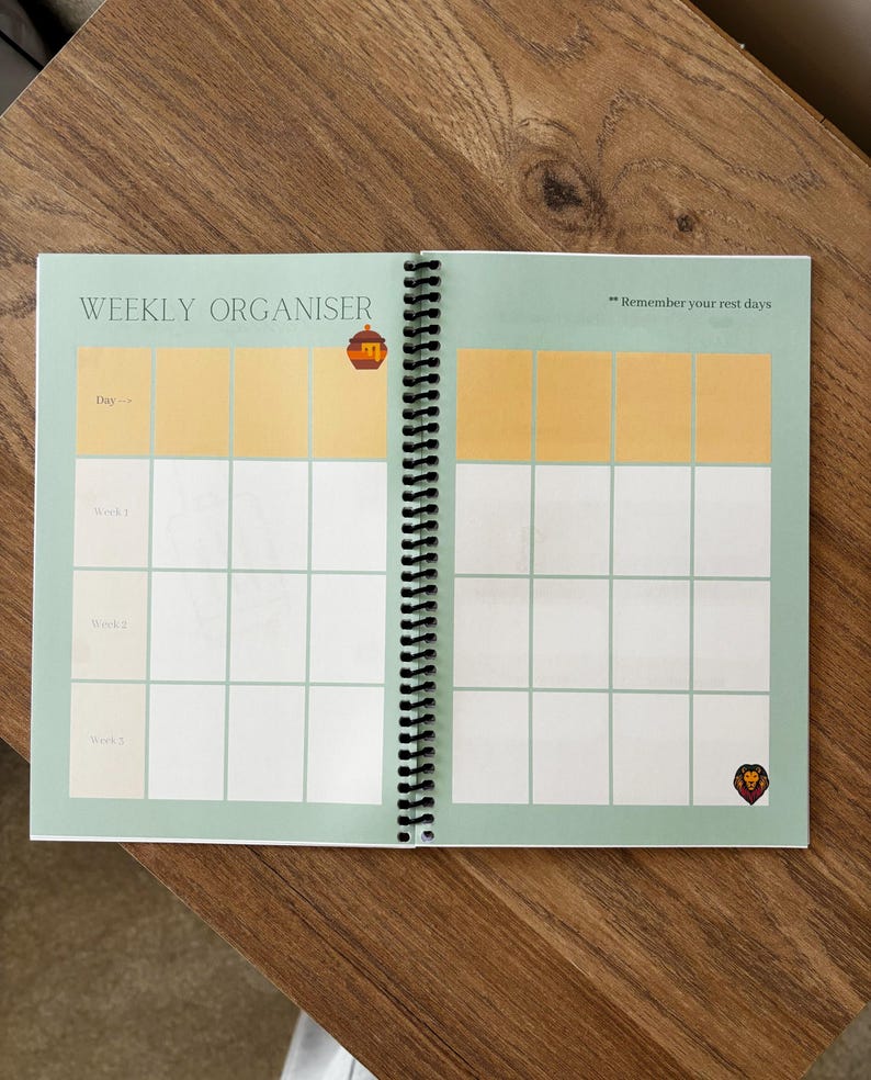 May include: A green weekly organiser with a spiral binding. The cover has the words "Weekly Organiser" and the text "Remember your rest days". There are illustrations of a lion and a beehive.