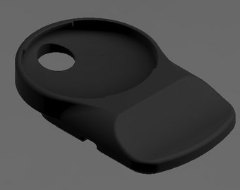 May include: A black, molded plastic object with a circular indentation and a smaller hole. The design features a curved, ergonomic shape with a flat, rectangular base. The object appears to be a holder or stand.