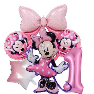 May include: A set of pink Minnie Mouse balloons. The collection features a large bow, two Minnie Mouse head balloons, a star, a number one balloon, and a Minnie Mouse character balloon in a polka dot dress.