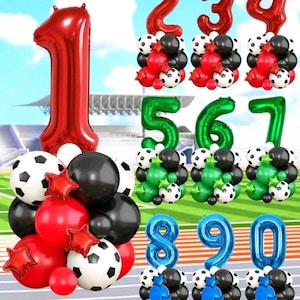 May include: A selection of number-shaped balloons in red, green, and blue, with soccer ball and star-shaped balloon clusters. Numbers 1-9 and 0 are displayed. The background shows a sky and a sports field.
