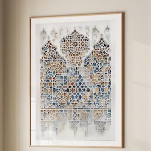 May include: A framed print with a geometric pattern in blue, brown, and white tones. The artwork hangs above a beige armchair with a grey cushion and a dark grey throw. The room has a neutral colour scheme, with a window and a door.