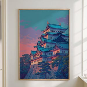 May include: A framed print depicting a Japanese castle with teal roofs and white walls, set against a sunset sky. The artwork is displayed in a room with a neutral color palette, a sofa, and a small side table. The print is in a wooden frame.