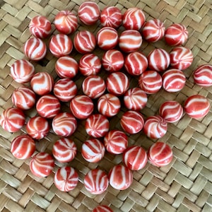 50+ red glass marbles vintage. All the same with a spiral.
