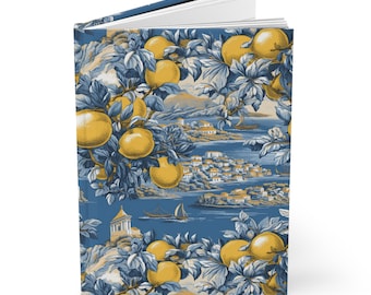 May include: A blue and yellow illustrated journal with a design of a coastal town and lemon trees. The journal has a hard cover and is perfect for writing down thoughts and ideas.