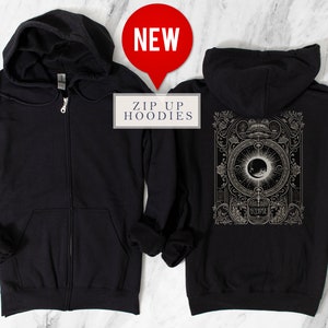 May include: Black zip-up hoodie with a graphic print of an eclipse on the back. The print features a detailed illustration of the sun and moon with the word "Eclipse" below.