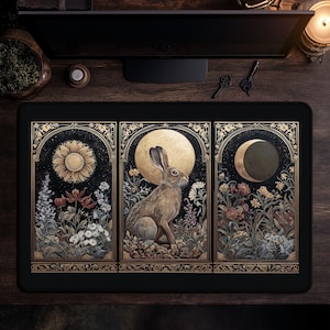 May include: Black rectangular mousepad featuring a detailed illustration of a hare in a moonlit garden. The design is divided into three panels with a sunflower, full moon, and crescent moon. The artwork includes floral elements and ornate gold borders.