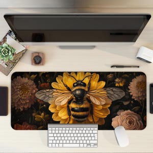 May include: A black and yellow bee with brown stripes sits on a yellow flower with brown and white petals. The bee is surrounded by other flowers and leaves on a dark background.