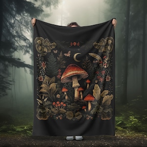 May include: A black tapestry with a dark forest scene featuring red and white mushrooms, green ferns, and other foliage. The tapestry has a crescent moon and butterflies in the top center.