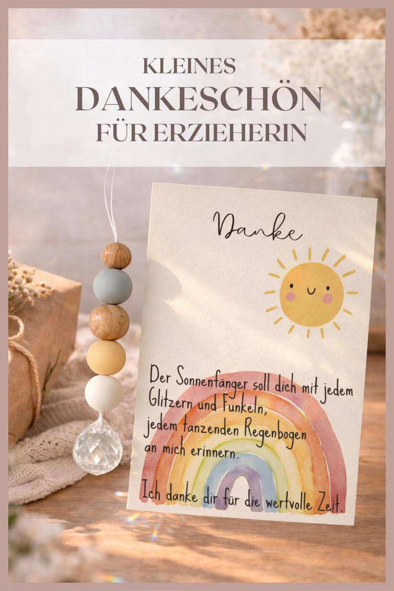 May include: A card with the text "Danke" and a watercolor rainbow and sun illustration. A string of wooden beads in various colors hangs next to the card. The text "KLEINES DANKESCH&Ouml;N F&Uuml;R ERZIEHERIN" is at the top.