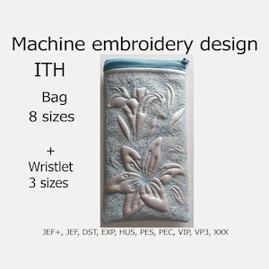May include: Machine embroidery design for a bag or wristlet featuring a white lily flower design on a light blue background. The design is available in 8 sizes for the bag and 3 sizes for the wristlet. The design is available in the following formats: JEF+, JEF, DST, EXP, HUS, PES, PEC, VIP, VP3, XXX.