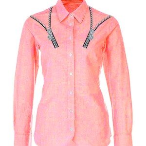 Pode incluir: Uma camisa rosa de manga comprida com bot&otilde;es e um design de z&iacute;per na gola.