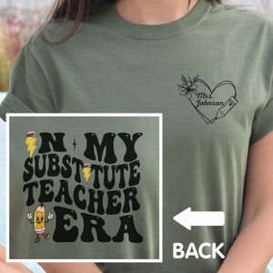 May include: A green t-shirt with the text "In My Substitute Teacher Era" in black with a yellow pencil graphic. The back of the shirt has a heart with the text "Mrs. Johnson" and a pencil graphic.