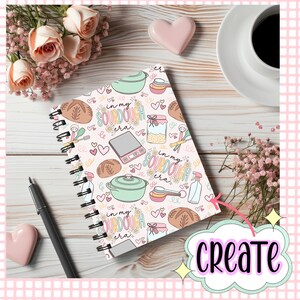 Pu&ograve; includere: Un quaderno a spirale con un motivo rosa, bianco e verde con illustrazioni di pane a lievitazione naturale, una bilancia, un misurino, un barattolo di lievito madre e il testo "in my sourdough era".
