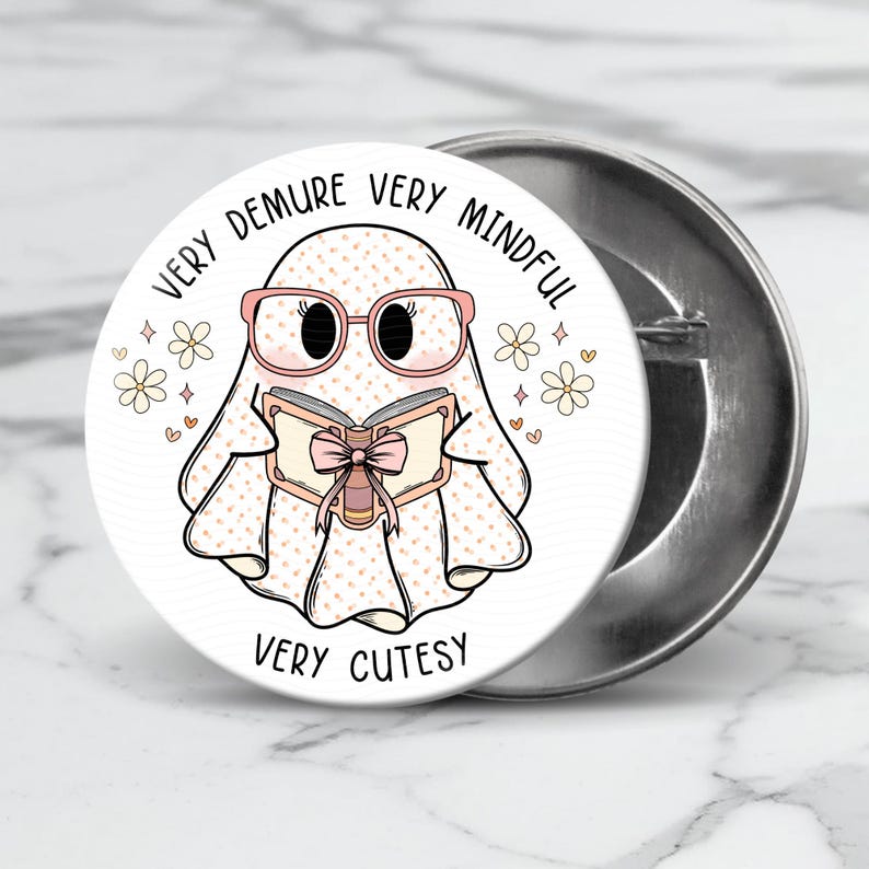 May include: A white ghost with pink glasses and a pink bow on a book is reading. The ghost is surrounded by white flowers and hearts. The text around the ghost says "Very Demure Very Mindful Very Cutesy".