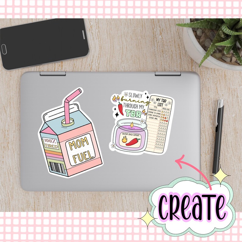 May include: Three colorful stickers on a silver laptop. The stickers are a cartoon illustration of a carton of "Mom Fuel" with a straw, a candle with the text "Slowly burning through my TBR" and a checklist labeled "My TBR List".