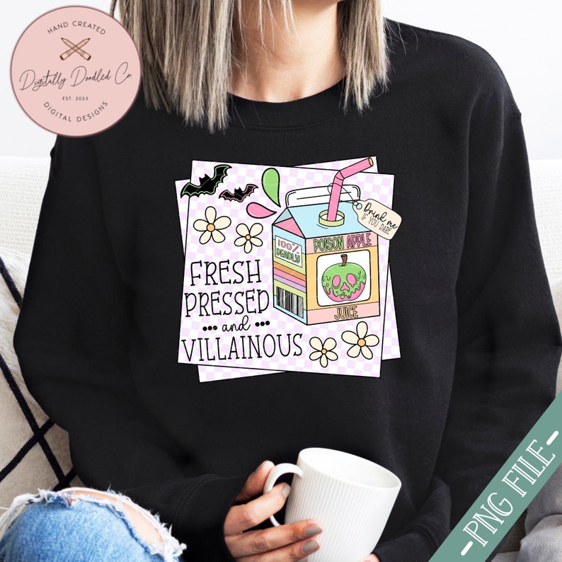 May include: A black sweatshirt with a graphic of a cartoon juice box with a green apple and the text "Fresh Pressed and... Villainous" and "Poison Apple Juice" on it. The juice box is surrounded by pink and white flowers and bats.