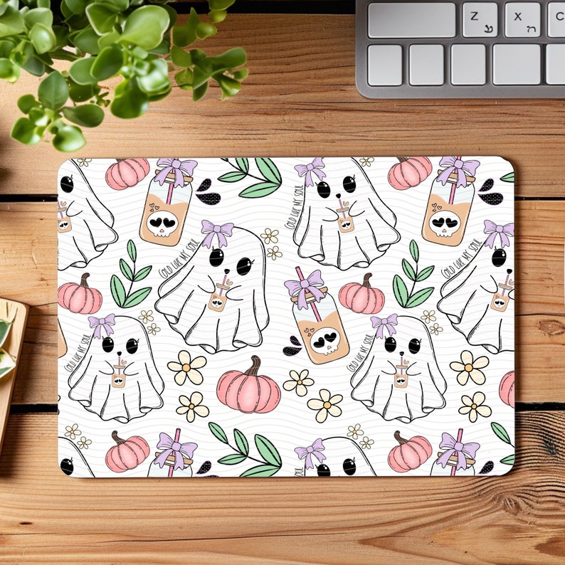 May include: A white background with a repeating pattern of cute ghosts holding mason jars with a pink and purple bow. The mason jars have a skull and crossbones design and the text "Cold Like My Soul". There are also pumpkins and leaves in the pattern.