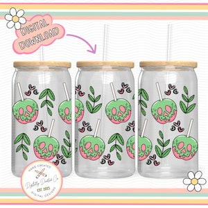 May include: Three clear glass tumblers with lids and straws, featuring a repeating pattern of green and pink poison apple designs with skull faces. The tumblers are on a pink and white striped background.