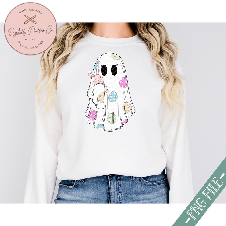 May include: A white ghost with a pink bunny rabbit inside. The ghost is decorated with pastel colored polka dots.