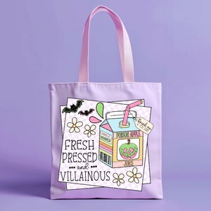 May include: A purple tote bag with a cartoon illustration of a juice box with a green apple and the text "Poison Apple Juice" and "Drink me if you dare". The text "Fresh Pressed and Villainous" is also on the bag.