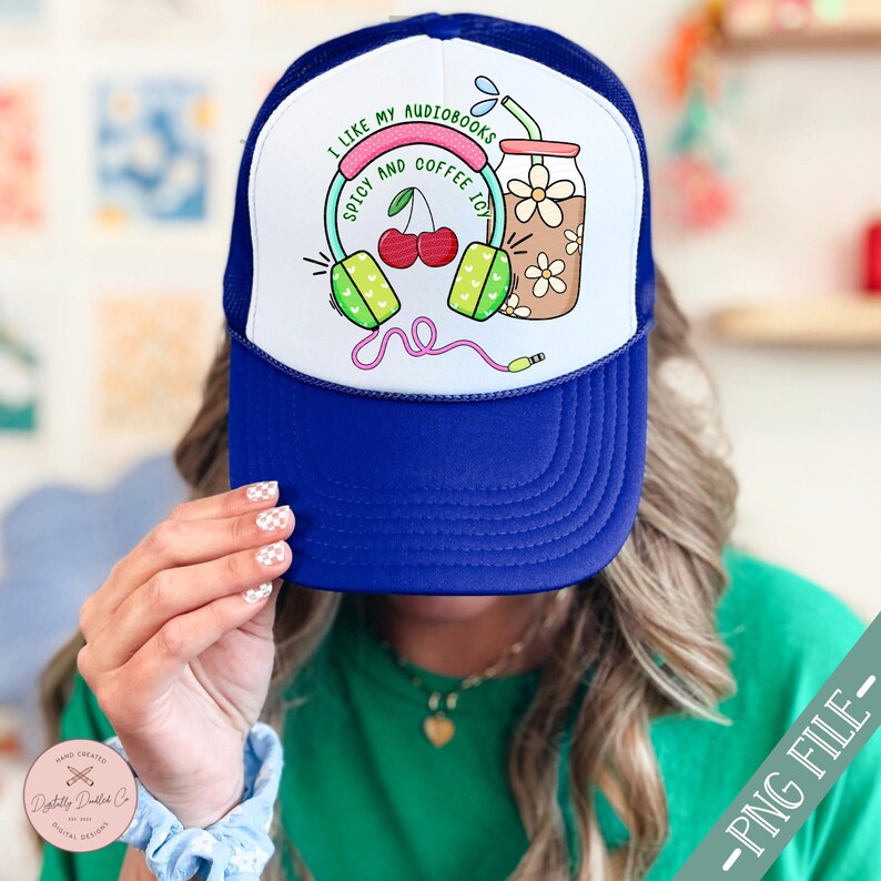 May include: Blue and white trucker hat with a graphic of headphones, cherries, and a glass of iced coffee. The text on the hat reads "I like my audiobooks, spicy and coffee too."