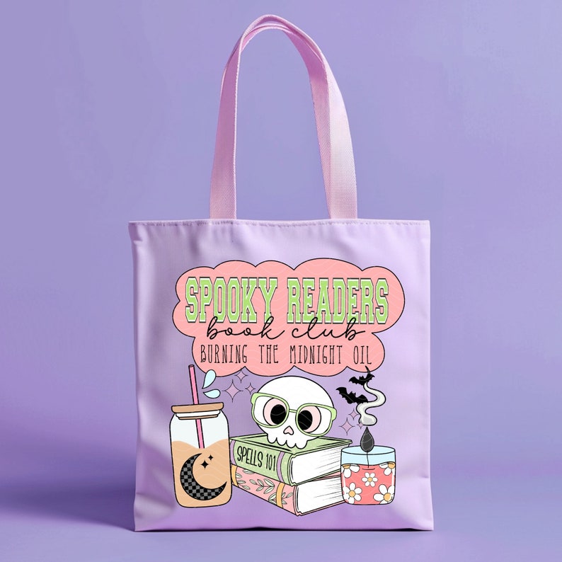 May include: A purple tote bag with a pink cloud design that says "Spooky Readers Book Club Burning the Midnight Oil". The design also includes a skull wearing glasses, a stack of books, a jar with a straw, and a candle.