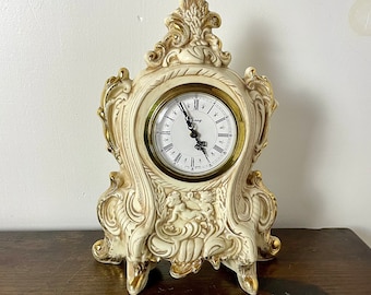 Reloj vintage de molde holandés con diseños de querubines ornamentados. TAL CUAL. Agrietado. No se da cuerda.