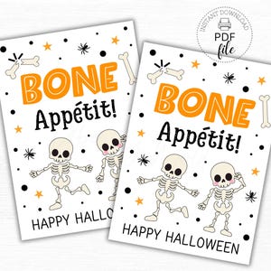 May include: Two white Halloween tags with orange text that reads "BONE Appétit!" and "Happy Halloween." The tags feature cartoon skeletons, bones, stars, and spiders. The tags are 6.35cm x 8.89cm.