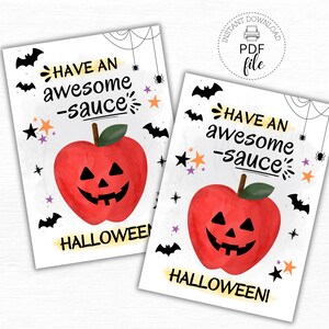 May include: Two Halloween-themed tags with a red apple carved like a jack-o'-lantern. The tags read "Have an awesome -sauce" and "Halloween!" with bats, stars, and spiderwebs. The tags are 2.5" x 3.5" in size.