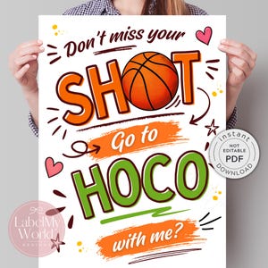 May include: A white poster featuring the text Don't miss your SHOT Go to HOCO with me? in orange and green lettering. The letter O in SHOT is replaced by an orange basketball graphic. The design includes small pink hearts, stars, and yellow dots.