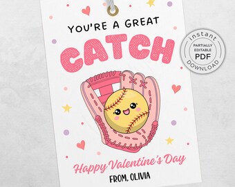May include: A Valentine's Day gift tag featuring a pink baseball glove holding a smiling yellow softball. The tag reads "YOU'RE A GREAT CATCH" and "Happy Valentine's Day". Includes the text "FROM, OLIVIA" and a small "instant PDF download" graphic.