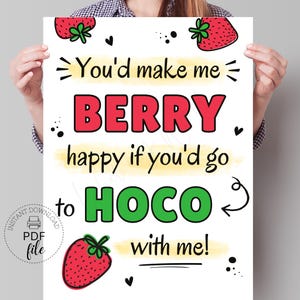 Puede incluir: Un póster blanco con el texto "You'd make me BERRY happy if you'd go to HOCO with me!" en rojo y verde. El póster tiene ilustraciones de fresas y un logotipo de "PDF file".