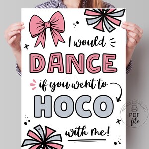 Könnte beinhalten: Ein weißes Poster mit rosa und grauen Akzenten. Der Text lautet "I would DANCE if you went to HOCO with me!" Dekorative Schleifen und Akzente umgeben den Text. Ein PDF-Datei-Download-Symbol befindet sich in der unteren rechten Ecke.