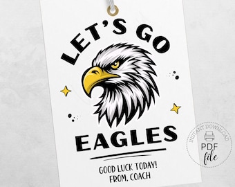 May include: White gift tag with the text "LET'S GO EAGLES" and "GOOD LUCK TODAY! FROM, COACH". The tag features a black and white eagle head with a yellow beak and two yellow stars.
