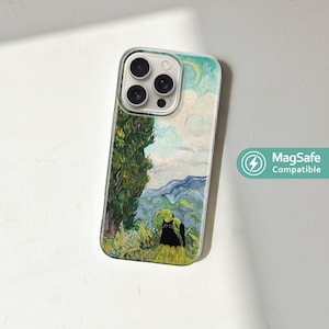 May include: Clear phone case featuring a painting of a landscape with a cypress tree, rolling hills, and a black cat. The case has a MagSafe Compatible logo.