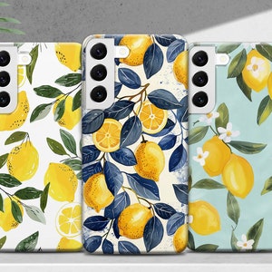 May include: Three phone cases with lemon designs. The first case has a white background with yellow lemons and green leaves. The second case has a white background with blue leaves and yellow lemons. The third case has a light blue background with yellow lemons and white flowers.