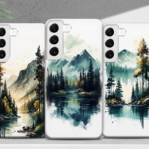 Puede incluir: Tres fundas para tel&eacute;fono con dise&ntilde;os de acuarela de un lago de monta&ntilde;a y un bosque. Las fundas son blancas con la parte posterior transparente y una protuberancia de c&aacute;mara negra.