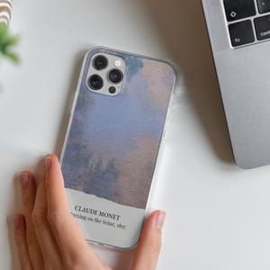 May include: A clear phone case with a watercolor-style design featuring a blue and purple sky. The case has a white label with the text "CLAUDE MONET,  Morning on the Seine, 1897".