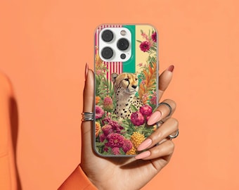 May include: A clear phone case featuring a cheetah illustration surrounded by colorful flowers and foliage. The design includes a vertical striped pattern in red, green, and yellow. The cheetah has a spotted coat and is set against a floral background.