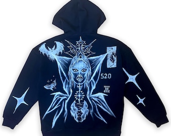 May include: Black hooded sweatshirt with a white graphic print of a woman with wings, a bat, stars, and the text "520 Trust No One".