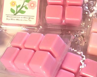 May include: Clear plastic clamshell packaging containing six pink soy wax melt cubes. The label reads Jolies Scented Candles Sweet Pea, Handcrafted in New York, Soy Wax Melts 2.5oz / 72g, featuring a graphic of a pink and yellow flower.