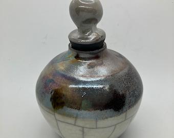 Raku fired copper and white crackle bottle wheel thrown vase with stopper
