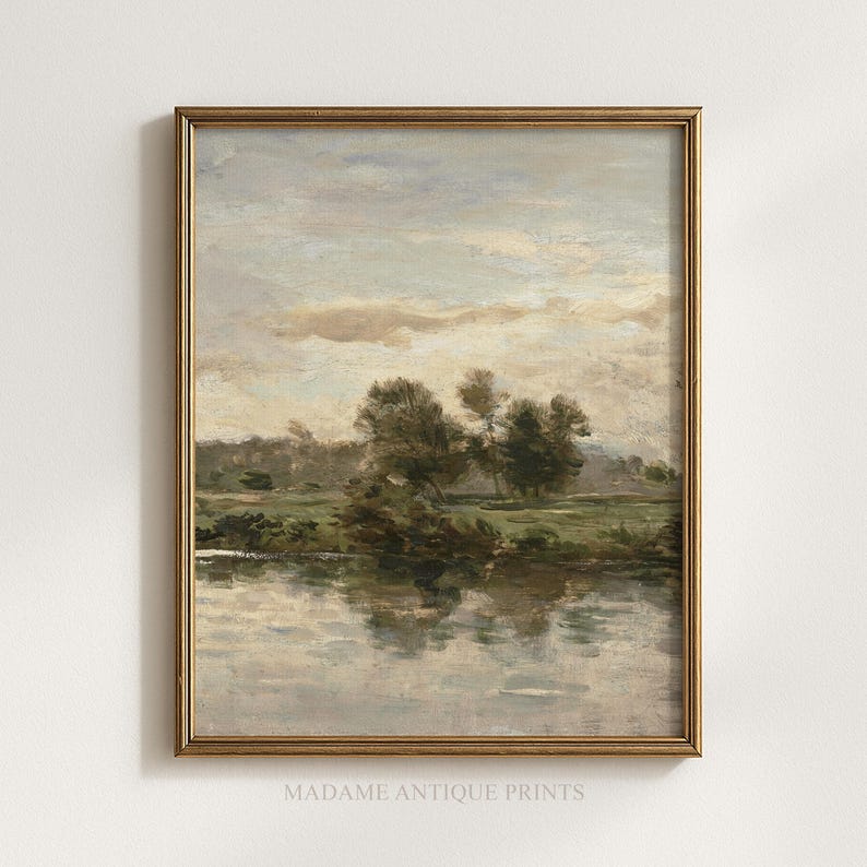 May include: A landscape painting in a gold frame depicting a calm river reflecting trees and a cloudy sky. The scene features muted tones of green, brown, and soft blue. The text MADAME ANTIQUE PRINTS is printed in small letters at the bottom centre.
