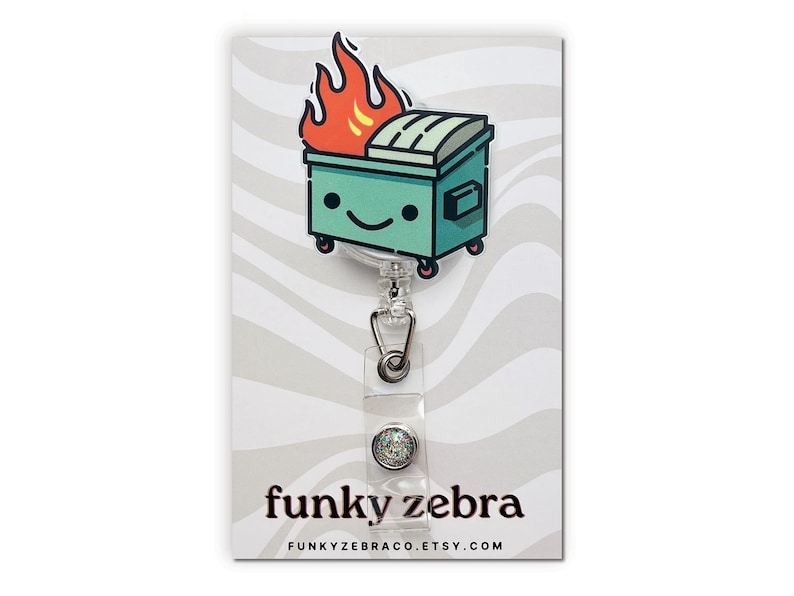 May include: A green and white cartoon dumpster with flames on top, attached to a clear retractable badge holder with a sparkly green button. The card reads "funky zebra" and "FUNKYZEBRACO.ETSY.COM".