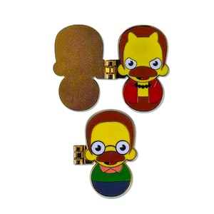 Peut inclure: Trois épingles en émail de personnages de dessins animés. Deux épingles présentent un visage jaune avec une moustache marron, des cheveux roux et une veste rouge. La troisième épingle est de couleur marron texturé. Toutes les épingles ont des charnières en métal doré.