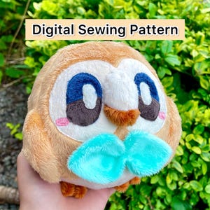 May include: A plush owl toy with a round body, featuring brown, white, blue, and pink details. The owl has large blue eyes, a turquoise bow, and the text "Digital Sewing Pattern" in a banner.