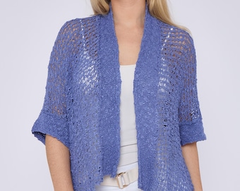 May include: A light blue open-front cardigan with a loose, open knit pattern. The cardigan has a relaxed fit and short sleeves.